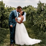 A photo of a couple sharing an intimate kiss wearing their wedding attire, taken in a scenic spot in La Grange.