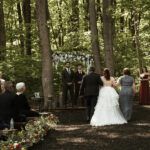 Wedding vows exchanged beneath the trees in Stone Manor’s forest ceremony area.