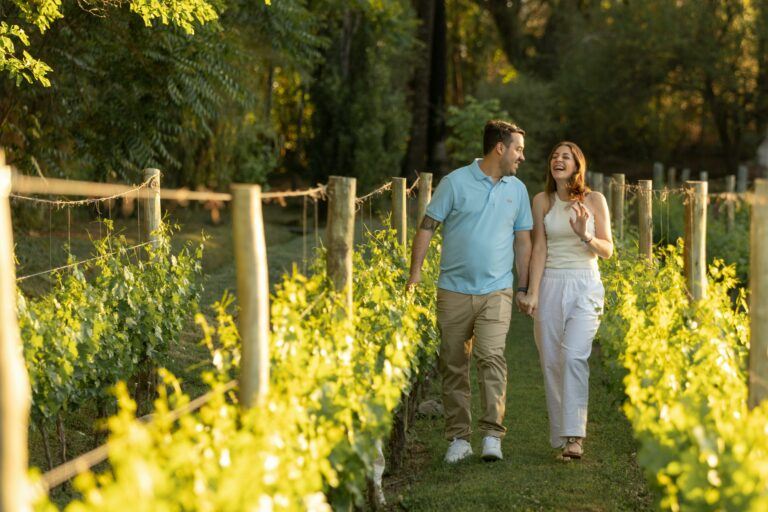 A couple walking through a vineyard