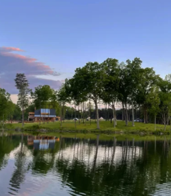 Tranquil lakeside view at Sunshine Ridge with wooded surroundings