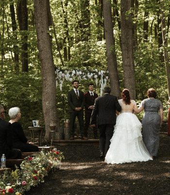 Wedding vows exchanged beneath the trees in Stone Manor’s forest ceremony area.