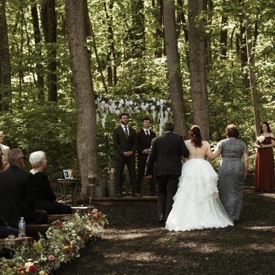 Wedding vows exchanged beneath the trees in Stone Manor’s forest ceremony area.